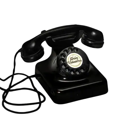 Schwarzes Wählscheibentelefon mit aufgewickelter Schnur und der Aufschrift Dein videofon auf der mittleren Wählscheibe.